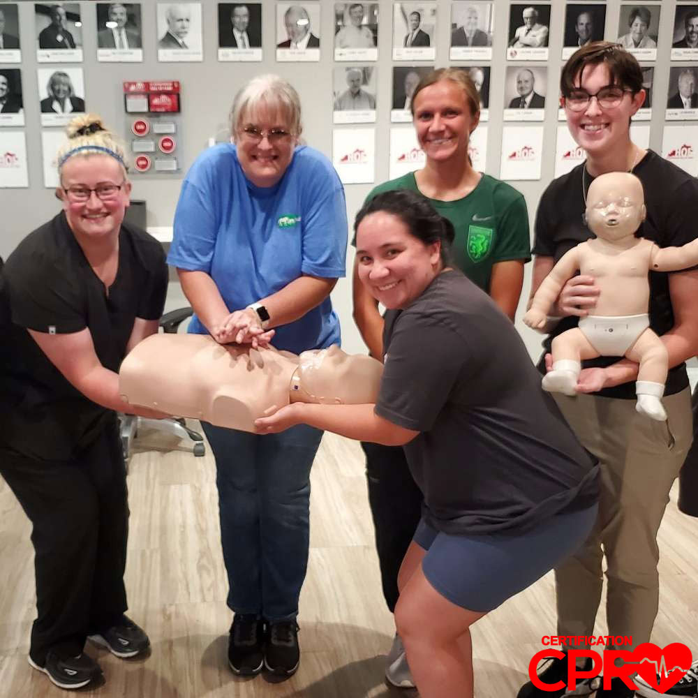 CPR training class in Tampa with students practicing on mannequins.